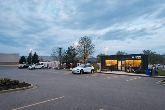 Clean DockYard Express modular amenity unit placed beside EV chargers during daytime